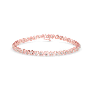 Graceful tennis bracelet featuring heart-shaped links and 2.62 ct round diamonds in 8.81 gm of 18kt gold. Lab grown diamond jewellery for an ethical choice.